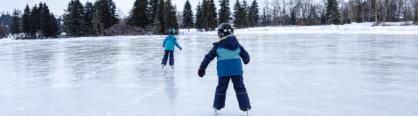 Children skating on the outdoor rink at Kickstart Skating Okotoks